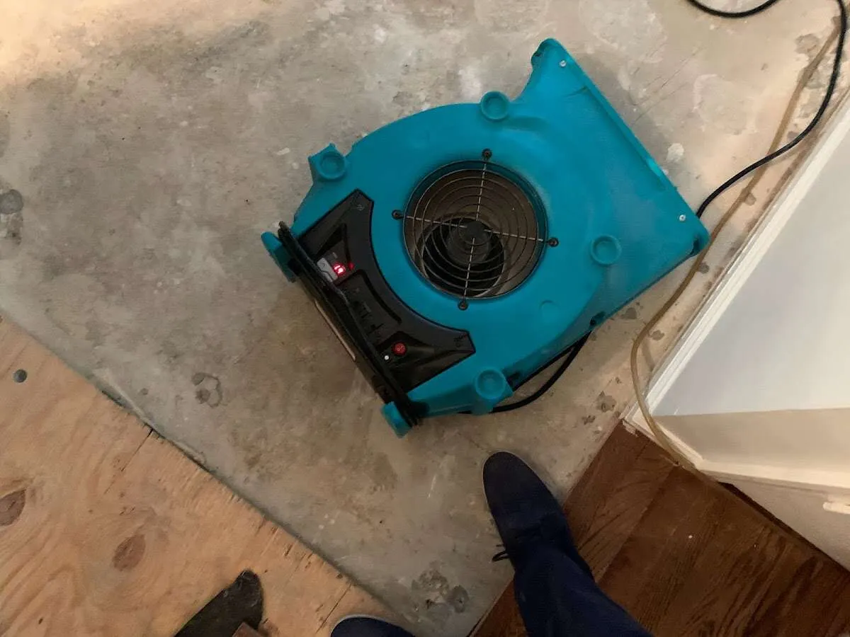 Air mover drying subfloor during Leak Detection & Repair in Waukegan